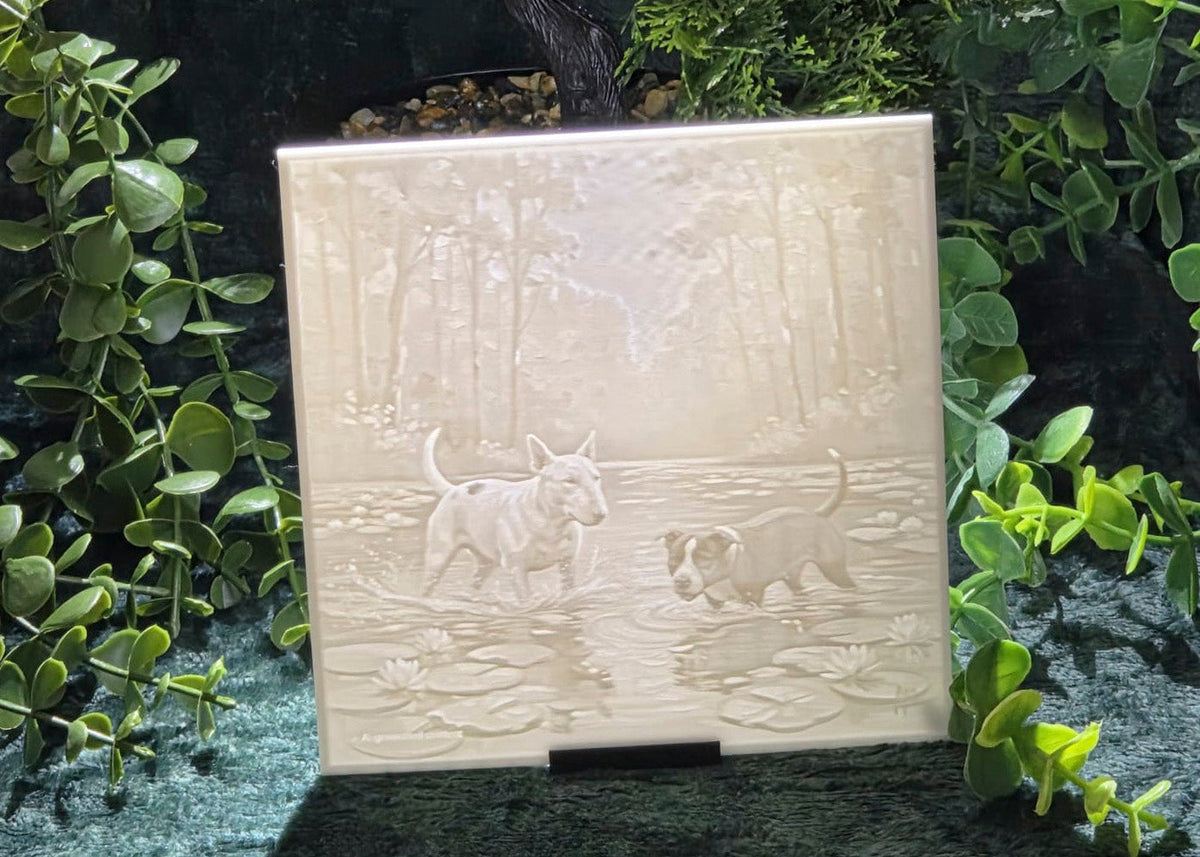 Staffy and bully dog lithophane panel displayed on a stand against green foliage