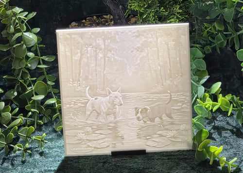 Staffy and bully dog lithophane panel displayed on a stand against green foliage